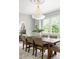 Bright dining room features a modern chandelier, neutral walls with molding, and a dining table with seating for six at 1563 Westwood Sw Ave, Atlanta, GA 30310