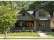 Charming two-story home with a welcoming front porch, lush lawn and professional landscaping at 1563 Westwood Sw Ave, Atlanta, GA 30310