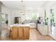 Bright kitchen with wood floors, marble countertops, stainless steel refrigerator, and large island at 1563 Westwood Sw Ave, Atlanta, GA 30310