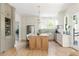 Bright open kitchen with stainless steel appliances, kitchen island, and light wood floors offer a modern design at 1563 Westwood Sw Ave, Atlanta, GA 30310