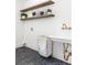 Laundry room with open shelving, a utility sink, and a rolling laundry basket at 1563 Westwood Sw Ave, Atlanta, GA 30310