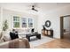 Bright and airy living room featuring a comfortable sofa, stylish decor, and hardwood flooring at 1563 Westwood Sw Ave, Atlanta, GA 30310