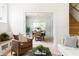 Bright and airy living room with hardwood floors, stylish furniture, and an open doorway to the dining area at 1563 Westwood Sw Ave, Atlanta, GA 30310