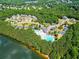 Aerial view of community pool, clubhouse, and surrounding green spaces near a lake at 201 Beacon Cv, Canton, GA 30114