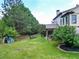 Expansive backyard with lush lawn, mature trees, and a cozy patio for outdoor enjoyment at 201 Beacon Cv, Canton, GA 30114