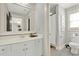 Neutral bathroom featuring a large mirror and access to a shower at 201 Beacon Cv, Canton, GA 30114