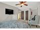 Bedroom with fan and chair; television mounted on the wall at 201 Beacon Cv, Canton, GA 30114