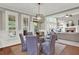 Elegant dining room featuring a glass table with seating for six and modern lighting fixture at 201 Beacon Cv, Canton, GA 30114