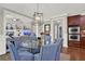 Dining area with a modern glass table and seating, adjacent to stainless steel kitchen appliances at 201 Beacon Cv, Canton, GA 30114