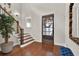 Inviting foyer boasts hardwood floors, a staircase, and a stylish door with decorative window at 201 Beacon Cv, Canton, GA 30114