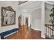 Elegant hallway with hardwood floors, wainscoting, and a decorative blue bench at 201 Beacon Cv, Canton, GA 30114