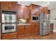 Spacious kitchen featuring stainless steel appliances and sleek dark wood cabinetry at 201 Beacon Cv, Canton, GA 30114