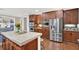 Kitchen with stainless steel appliances, dark wood cabinets and an island with white countertop at 201 Beacon Cv, Canton, GA 30114