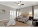 Comfortable bedroom featuring a ceiling fan and a cozy sitting area at 201 Beacon Cv, Canton, GA 30114