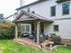 Backyard patio area with covered seating, grill, and lush landscaping at 201 Beacon Cv, Canton, GA 30114