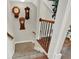 Carpeted staircase with wooden railing and decorative wall clocks at 201 Beacon Cv, Canton, GA 30114