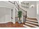 Bright foyer with a staircase featuring wood treads and black iron spindles at 201 Beacon Cv, Canton, GA 30114