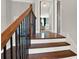 Staircase with wooden treads, white risers, and black iron balusters leading upstairs at 201 Beacon Cv, Canton, GA 30114