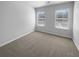 Clean bedroom with neutral walls, carpeted floor and two picture windows at 2382 Capella Sw Cir, Atlanta, GA 30331