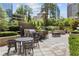 Outdoor grilling area with tables, chairs, and greenery for enjoyable outdoor dining at 3445 Stratford Ne Rd # 2402, Atlanta, GA 30326