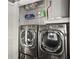 Laundry room with a modern front-load washer and dryer set and shelving for storage at 3445 Stratford Ne Rd # 2402, Atlanta, GA 30326