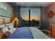 Well-lit bedroom offers city views, modern decor, and wood-look flooring at 3445 Stratford Ne Rd # 2402, Atlanta, GA 30326