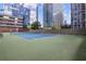 Well-maintained tennis court surrounded by greenery and modern buildings for active residents at 3445 Stratford Ne Rd # 2402, Atlanta, GA 30326