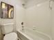 Full bathtub shower features sleek white tile and chrome fixtures in an updated bathroom at 3850 Westwick Nw Way, Kennesaw, GA 30152