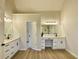 Well-lit bathroom with dual sinks, a vanity, and modern finishes at 3850 Westwick Nw Way, Kennesaw, GA 30152