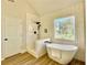 Modern bathroom with a tub and shower, sleek black fixtures, and plenty of natural light at 3850 Westwick Nw Way, Kennesaw, GA 30152