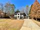 Charming two-story home with manicured lawn and driveway and mature trees at 3850 Westwick Nw Way, Kennesaw, GA 30152