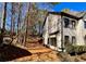 White siding and black trim on a two-story house with large windows, surrounded by trees at 3850 Westwick Nw Way, Kennesaw, GA 30152