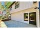 Back patio with glass door, white siding, and black trim on a two-story house at 3850 Westwick Nw Way, Kennesaw, GA 30152