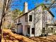 White siding and black trim on a two-story house with a chimney surrounded by trees at 3850 Westwick Nw Way, Kennesaw, GA 30152