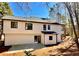 Two story house with white siding, black trim and windows, concrete back patio, and chimney at 3850 Westwick Nw Way, Kennesaw, GA 30152