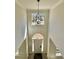 Two-story foyer with chandelier and arched doorway at 3850 Westwick Nw Way, Kennesaw, GA 30152