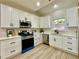 Well-lit kitchen with white cabinetry, modern appliances, and a stylish backsplash at 3850 Westwick Nw Way, Kennesaw, GA 30152