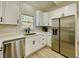 Kitchen featuring stainless appliances, white countertops and cabinetry, and a window view at 3850 Westwick Nw Way, Kennesaw, GA 30152