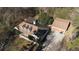 Aerial view showcasing the home's roof, dormers, detached garage, and driveway at 3890 Irwin Bridge Nw Rd, Conyers, GA 30012