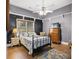 Bedroom with hardwood floors, ceiling fan, and gray accent wall at 3890 Irwin Bridge Nw Rd, Conyers, GA 30012