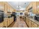 Traditional kitchen showcasing granite countertops, tiled backsplash, wood cabinets, and an open flow to the living area at 3890 Irwin Bridge Nw Rd, Conyers, GA 30012