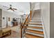 Bright living room with hardwood floors connects to a staircase with wooden steps and an iron railing at 3890 Irwin Bridge Nw Rd, Conyers, GA 30012