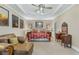 Spacious main bedroom featuring tray ceiling, fan, lounge furniture, and neutral wall color at 3890 Irwin Bridge Nw Rd, Conyers, GA 30012