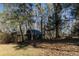 Rustic outbuilding surrounded by trees and foliage, nestled on a charming property at 3890 Irwin Bridge Nw Rd, Conyers, GA 30012