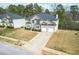 Aerial view of a two-story home and driveway, showing the manicured lawn and surrounding neighborhood landscape at 4526 Warren Mill Trl, Ellenwood, GA 30294