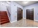 Basement area with tile floor, wood stairs, and a sliding barn door at 4526 Warren Mill Trl, Ellenwood, GA 30294