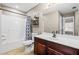 Bathroom features a white shower/tub combination, a dark wood vanity and bronze fixtures at 4526 Warren Mill Trl, Ellenwood, GA 30294