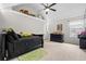 Well-lit bedroom featuring a bed with dark furnishings and carpeted floors at 4526 Warren Mill Trl, Ellenwood, GA 30294