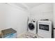 Bright laundry room with white washer and dryer and ample storage space at 4526 Warren Mill Trl, Ellenwood, GA 30294