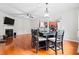 Open concept living room, featuring a decorative fireplace, hardwood flooring, and modern lighting at 4526 Warren Mill Trl, Ellenwood, GA 30294